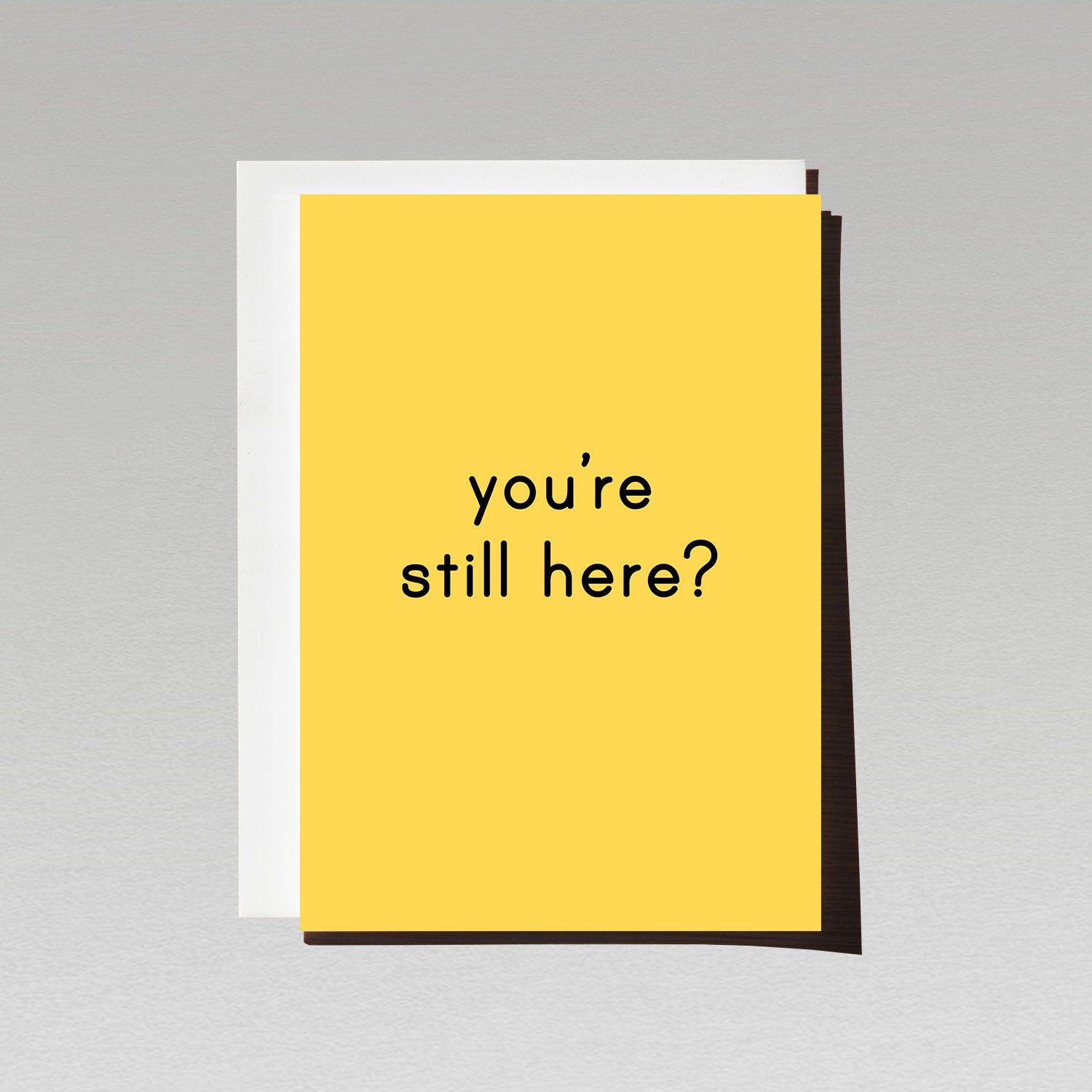 Greeting card with minimalist white text youre still here? on yellow background
